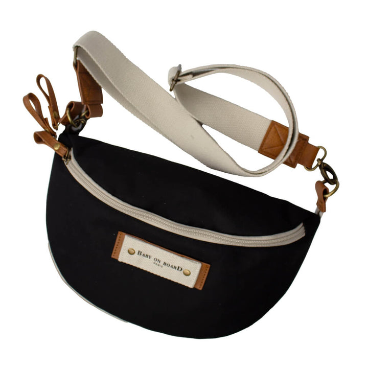 Sac banane à langer Armelle noir Baby on Board avec bandoulière ajustable et détails en cuir, élégant et pratique pour les parents en déplacement.