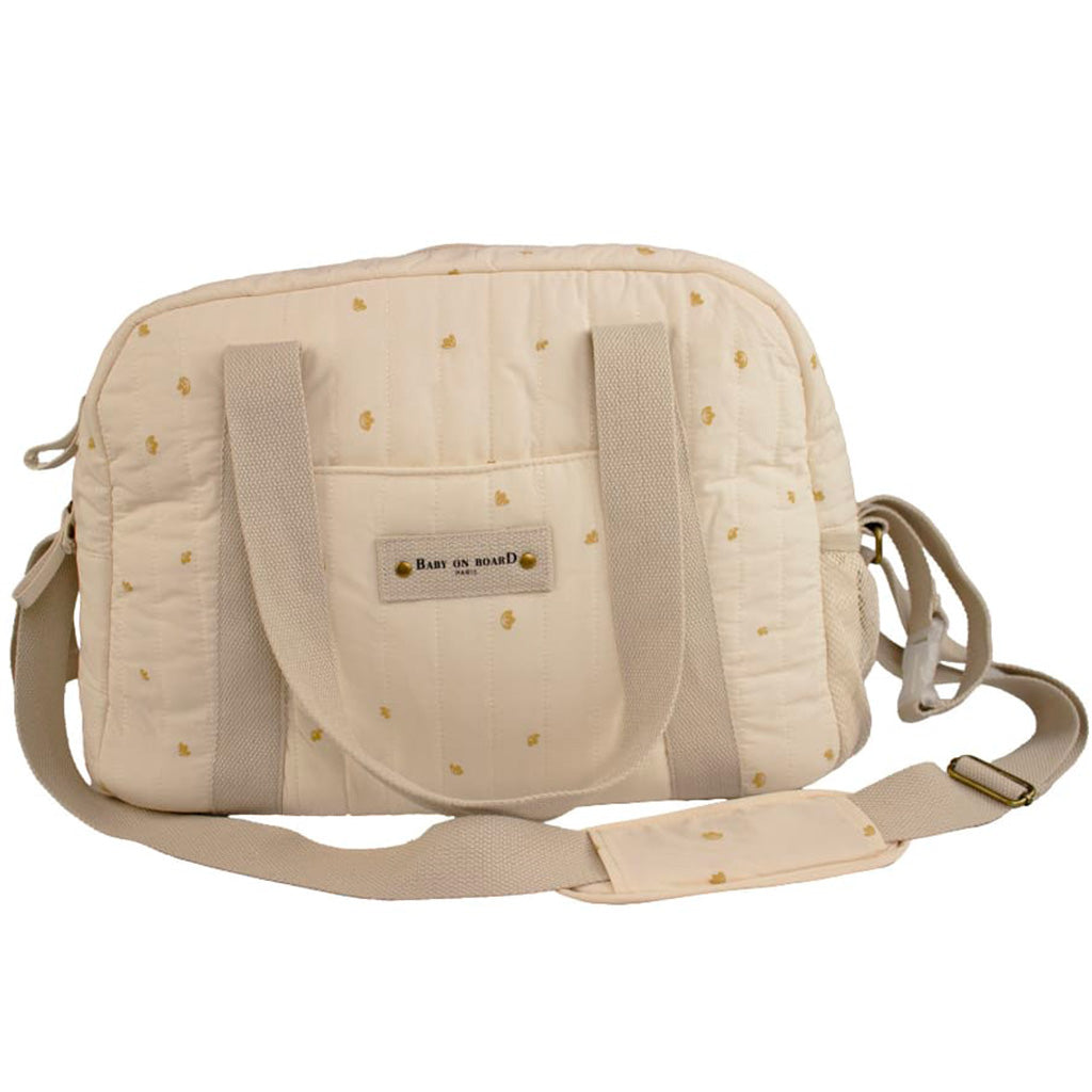 Sac à langer Simply Coton Baby on Board blanc crème avec détails dorés, léger et élégant, parfait pour transporter les essentiels de bébé.